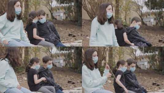 戴好口罩的三个小孩坐在路边的小木棍高清在线视频素材下载