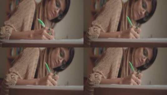 女人用笔在本子上写字高清在线视频素材下载