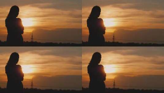 夕阳下一个女人凝视远方的孤独剪影高清在线视频素材下载