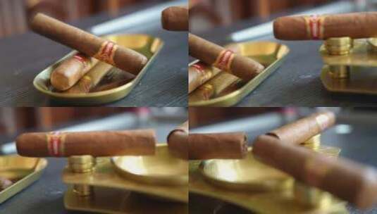 雪茄三根在烟缸上高清在线视频素材下载