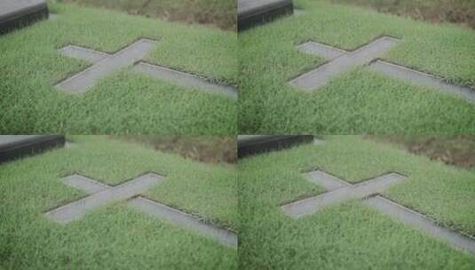 草地坟墓中水泥十字架的特写高清在线视频素材下载
