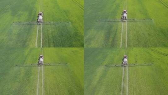 春季农业喷雾器向绿地喷洒杀虫剂的航拍镜头高清在线视频素材下载