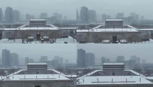 航拍陕西省西安市大雪中的西安安远门古城墙高清在线视频素材下载