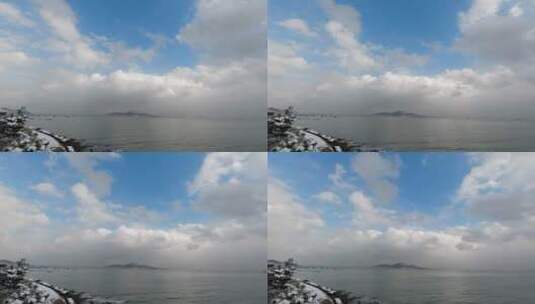 雪后的威海湾刘公岛蓝天白云雪景延时高清在线视频素材下载