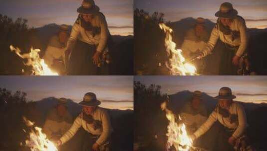 夜晚妇女在野外烧篝火高清在线视频素材下载