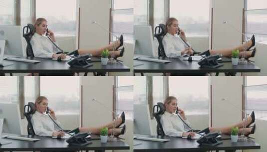 女经理坐在办公室的工作场所，腿放在桌子上打电话高清在线视频素材下载