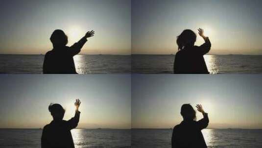 美女站在海边向太阳挥手女人招手开心挥手高清在线视频素材下载