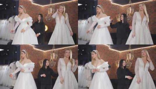 两位新娘正在婚礼沙龙婚纱陈列室试穿婚纱高清在线视频素材下载