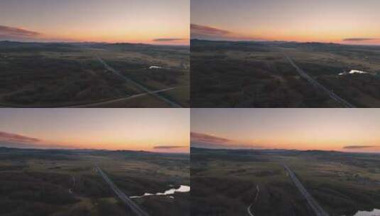 航拍夕阳下穿过草原的高速公路高清在线视频素材下载