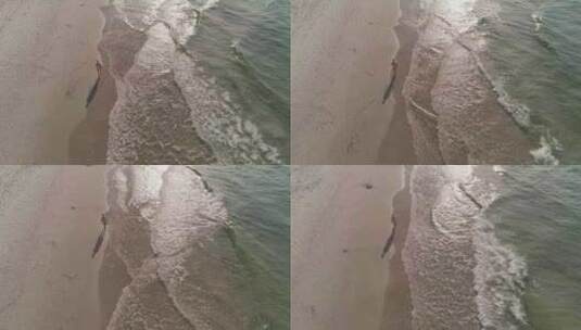 日出时，一名身穿比基尼的美丽女子正在海边散步。美国4k高清在线视频素材下载