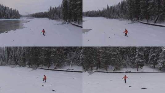 航拍男人艰难地走在新疆喀纳斯河边的雪地里高清在线视频素材下载