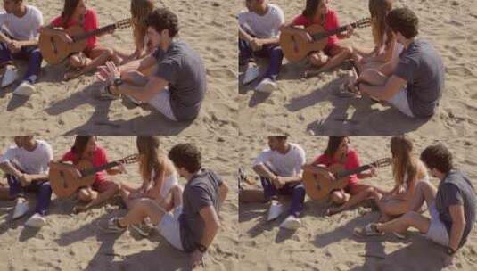 朋友在海滩上放松弹吉他高清在线视频素材下载