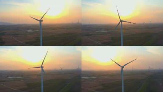 风车发电-黄昏日落时分田野上的风车在旋转高清在线视频素材下载