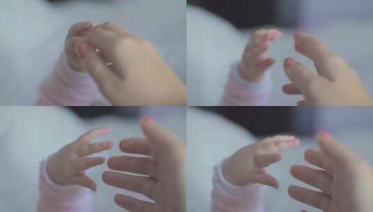 婴儿触碰母亲的手高清在线视频素材下载