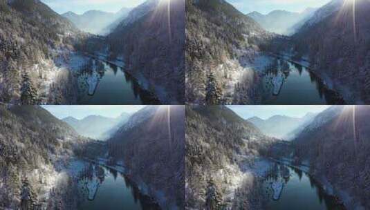 4k逆光下冬天雪山森林湖泊高清在线视频素材下载