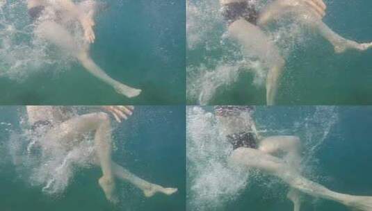 男子水下游泳的慢动作镜头高清在线视频素材下载