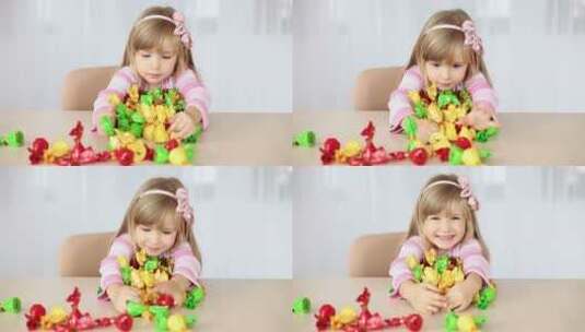小女孩抱着桌子上的糖果欢笑高清在线视频素材下载