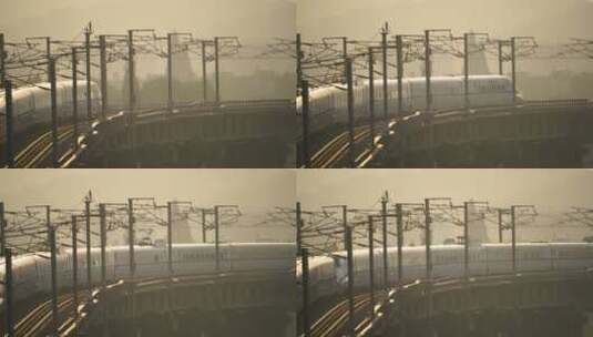 日出阳光下在城市中穿行的高铁火车高清在线视频素材下载