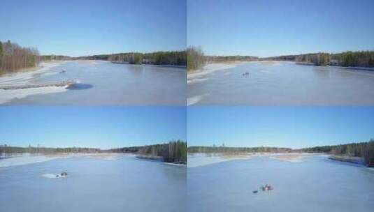 空中雪地摩托在结冰的湖面上行驶高清在线视频素材下载