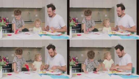 小女孩和小男孩以及他们的父亲正在用彩纸和胶水做应用高清在线视频素材下载