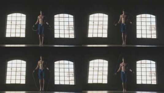 一个肌肉发达的男人在健身房跳绳训练。概念高清在线视频素材下载