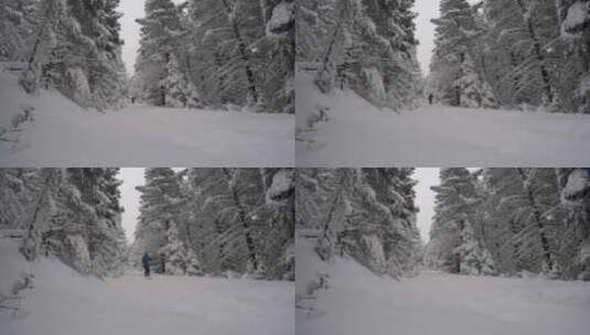 圣诞节假期，一名男子在白雪覆盖的山上越野高清在线视频素材下载