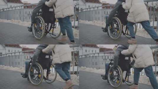 轮椅上的残疾人和朋友在散步高清在线视频素材下载