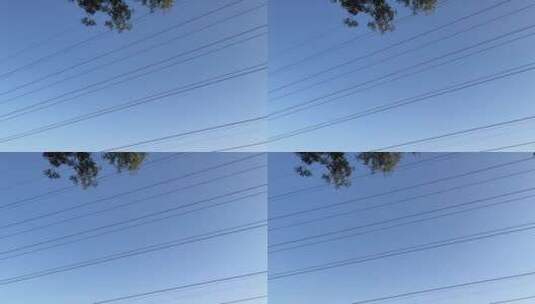 蓝色天空下,远处一架飞机在盘旋高清在线视频素材下载