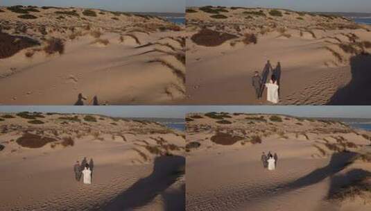 新婚夫妇牵手漫步在沙滩海岸高清在线视频素材下载