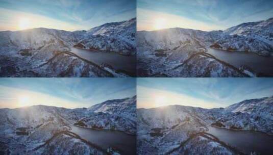 航拍冬季高山湖泊雪景山峰日出高清在线视频素材下载