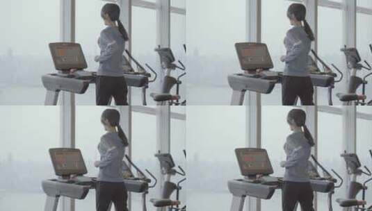 亚洲中国女性用跑步机跑步高清在线视频素材下载