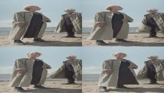 两个人穿着风衣站在海边高清在线视频素材下载