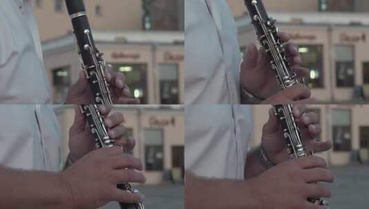穿着白衬衫的音乐家演奏单簧管高清在线视频素材下载
