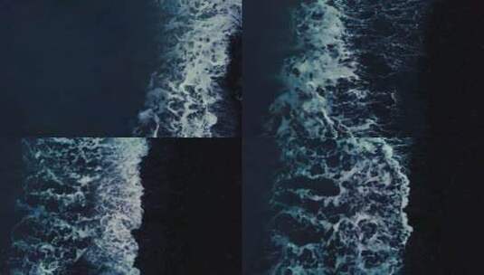 海浪在黑暗的海岸上破碎的俯视图。天线高清在线视频素材下载