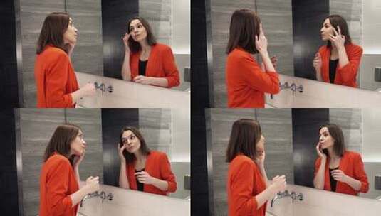 年轻漂亮的女人在浴室照镜子高清在线视频素材下载