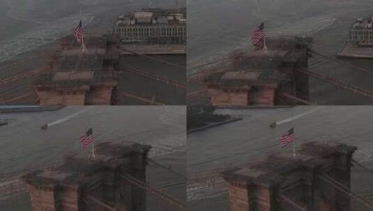 美国航空：布鲁克林大桥上空的美国国旗和曼哈顿东河景特写圆环飞行高清在线视频素材下载