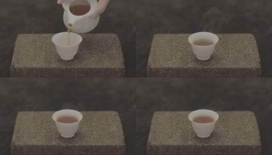 茶砖上的茶杯倒茶水高清在线视频素材下载