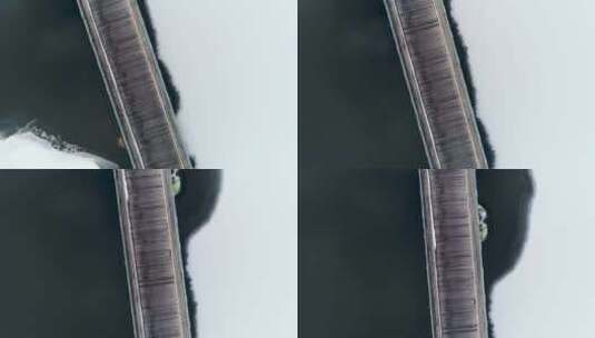 五大连池冬季雪地湖泊木桥航拍高清在线视频素材下载