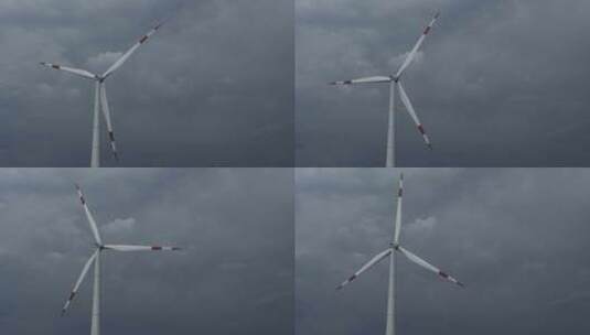 乌云下转动的风电轮机【4K】高清在线视频素材下载