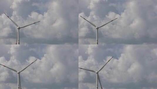 云层下的正在旋转运作的风力发电机高清在线视频素材下载