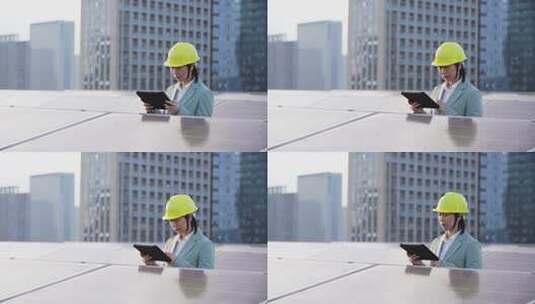 女性工程师拿着平板电脑在屋顶光伏发电站高清在线视频素材下载