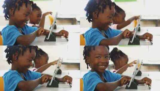 男孩在教室里使用平板电脑高清在线视频素材下载