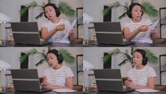 女性对着电脑讲述纸上的内容高清在线视频素材下载