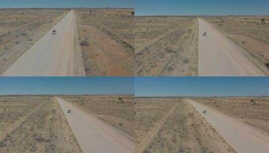 沙漠空旷尘土飞扬的高速公路上快速行驶车辆的空中旋转跟拍高清在线视频素材下载