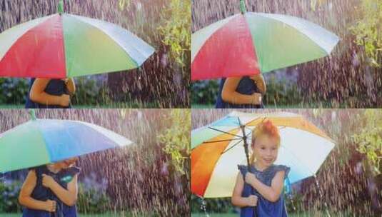 小女孩在彩色雨伞下躲雨高清在线视频素材下载