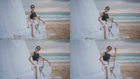 魅力女孩在海岸专业模特拍摄太阳镜摆姿势海高清在线视频素材下载