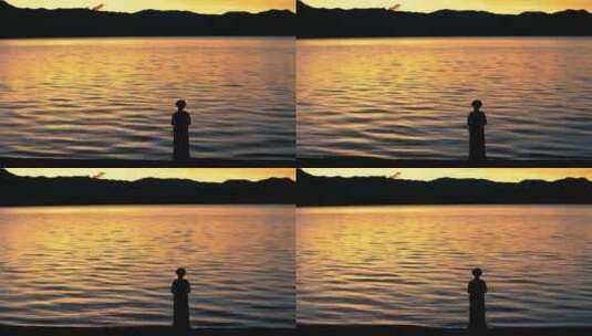 湖边少女的剪影 泸沽湖畔的摩梭少女高清在线视频素材下载