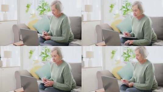 笔记本电脑、写作和投资文件与一位老妇人在高清在线视频素材下载