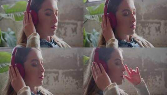 女人一边听音乐一边把耳机贴在耳朵上高清在线视频素材下载