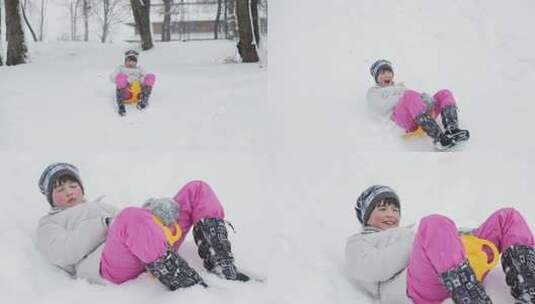 蹒跚学步的女孩在雪山上下雪橇高清在线视频素材下载